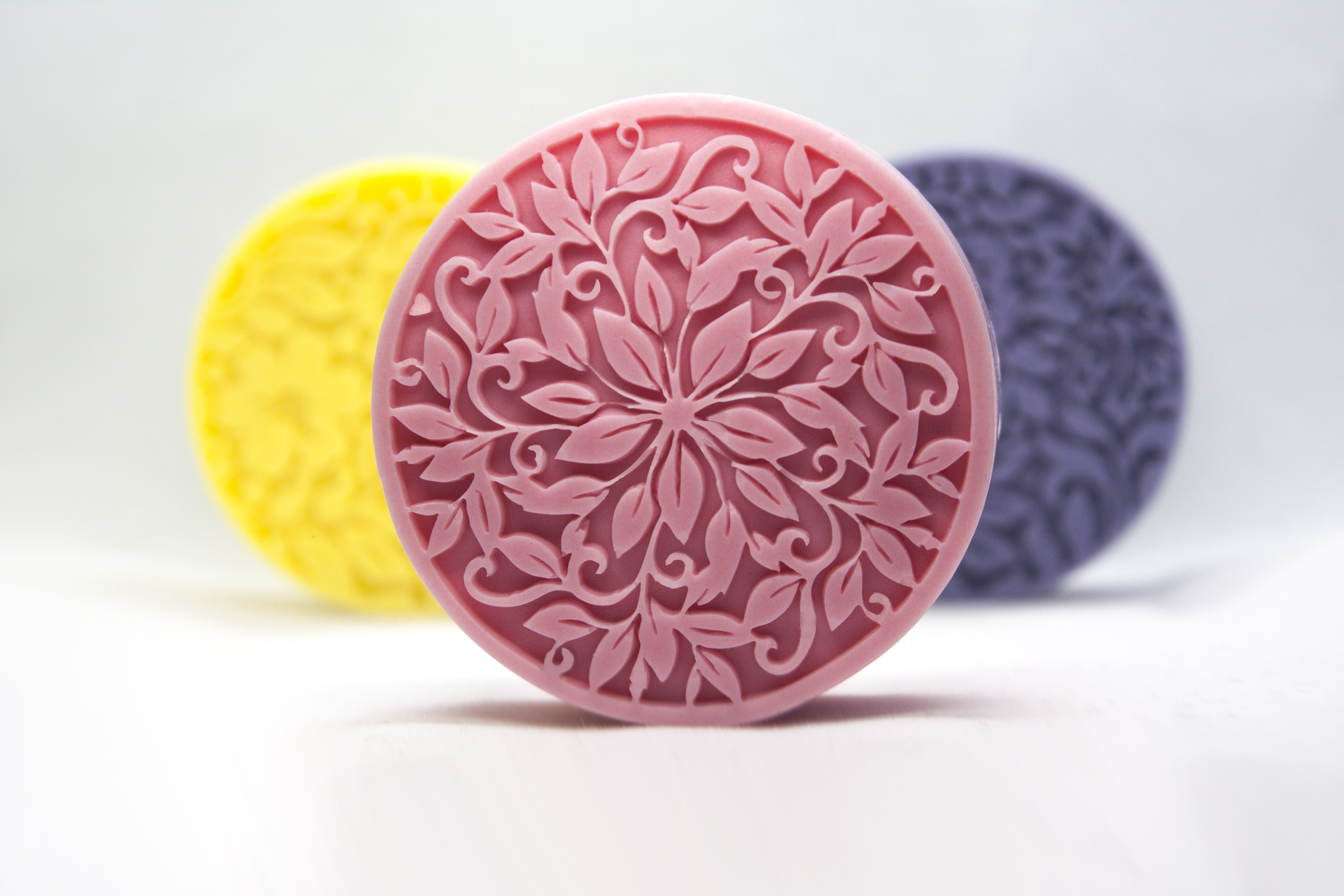 Three of Bluish Pink's handmade circle soaps.